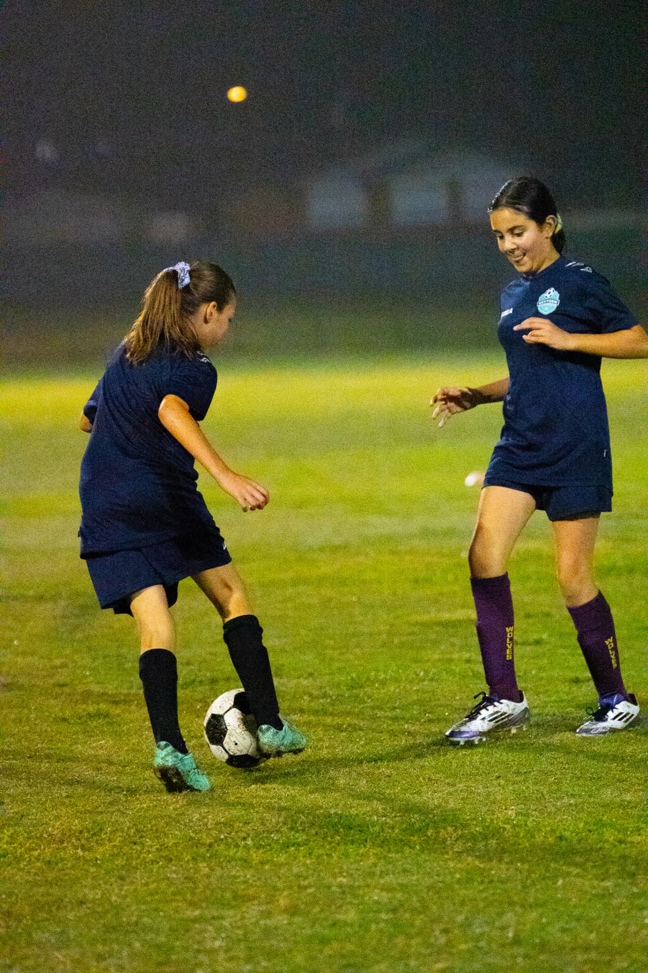 Two NextGen players practising together on the pitch